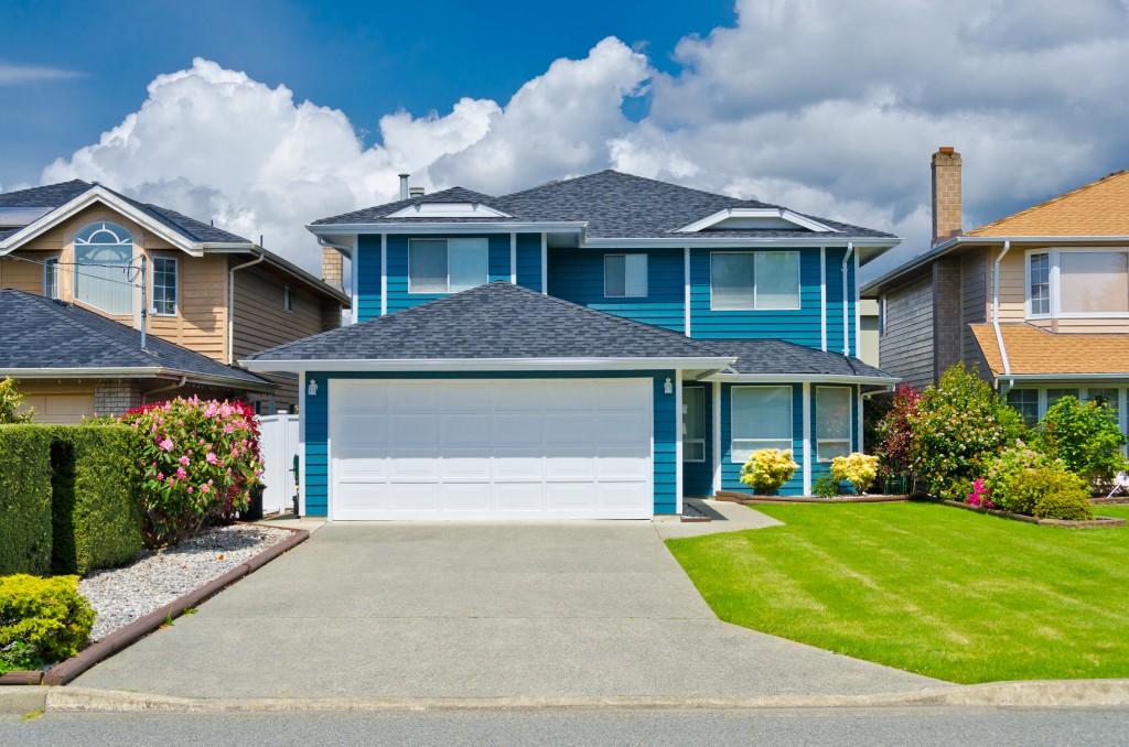 Blue single family residence house on suburban street